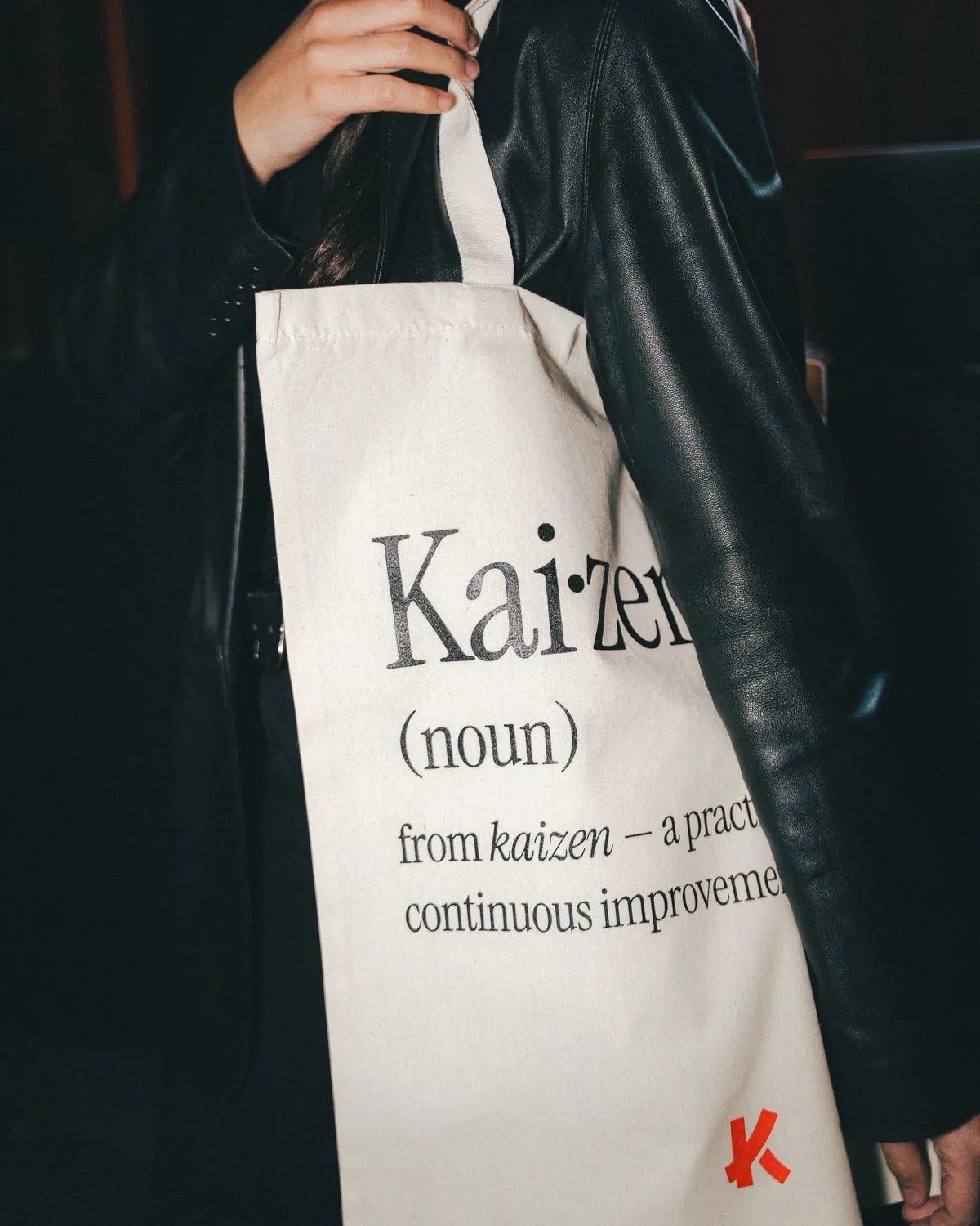 A Kaizer tote bag printed with the definition of kaizen